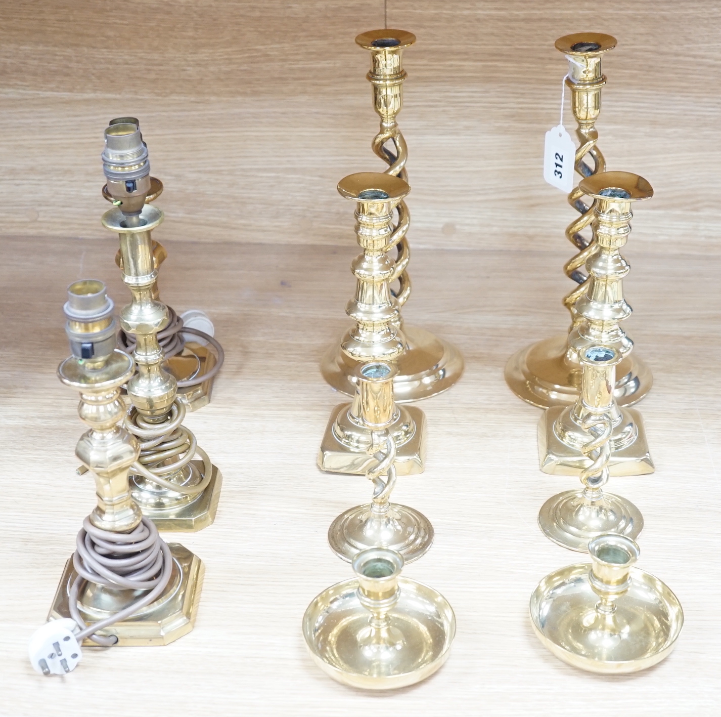 Four pairs of brass candlesticks, and another three converted to lamps, tallest 31cms high